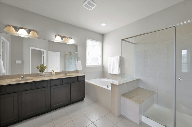 bathroom featuring tile flooring, oversized vanity, double sink, and plus walk in shower