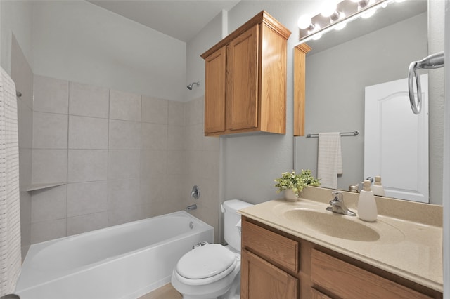 full bathroom featuring tiled shower / bath, toilet, and vanity