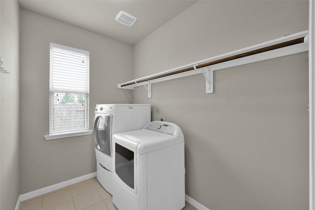 washroom featuring light tile flooring and independent washer and dryer