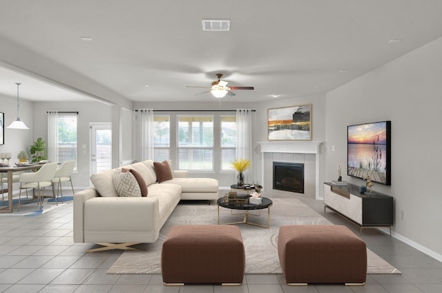 living room with tile floors, ceiling fan, and a fireplace