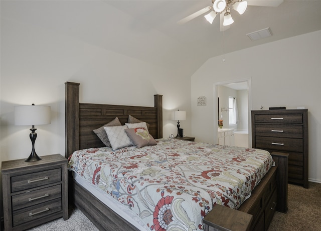 bedroom featuring vaulted ceiling, ensuite bathroom, ceiling fan, and carpet