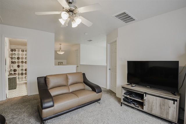 carpeted living room featuring ceiling fan