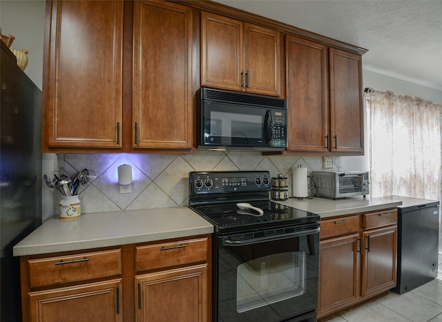 kitchen featuring black appliances, light tile patterned floors, and decorative backsplash