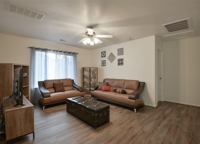 living room with hardwood / wood-style flooring and ceiling fan