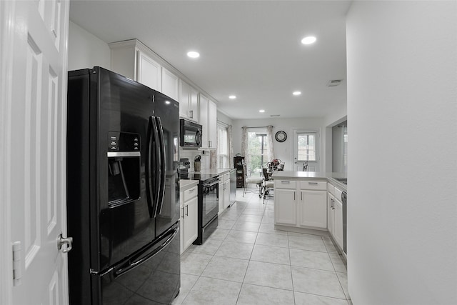 kitchen with visible vents, black appliances, a peninsula, recessed lighting, and white cabinetry