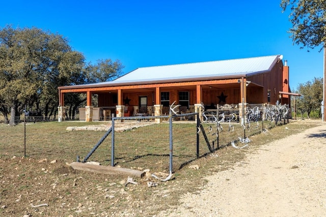 exterior space with an outbuilding, an exterior structure, and metal roof