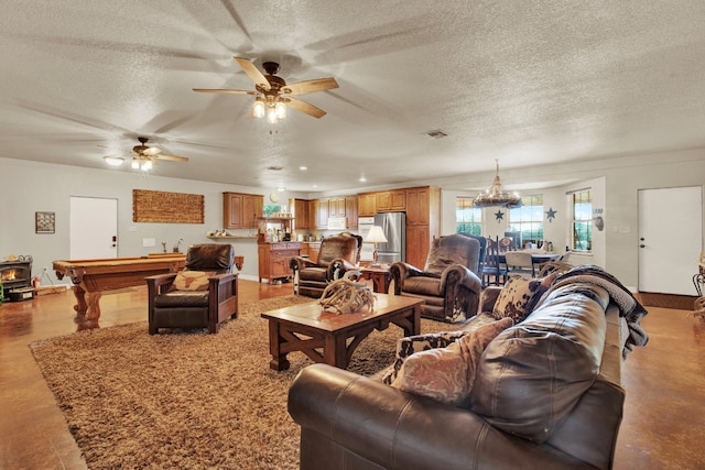 living room with billiards, ceiling fan, and a textured ceiling