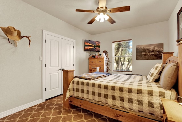 carpeted bedroom featuring a closet and ceiling fan