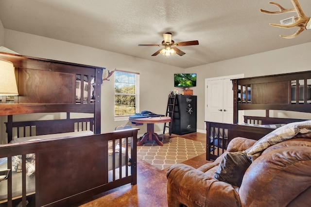 bedroom featuring concrete floors and a textured ceiling