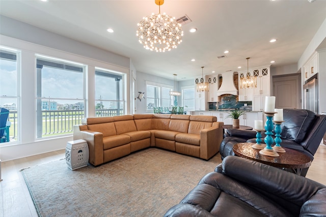 living area with light wood-type flooring, an inviting chandelier, visible vents, and recessed lighting