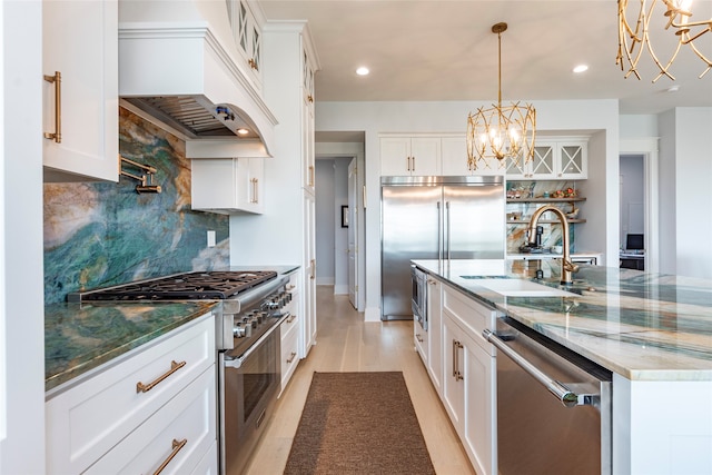 kitchen with dark stone counters, white cabinets, custom exhaust hood, high quality appliances, and pendant lighting