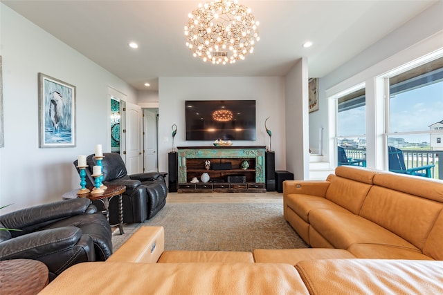 living room featuring a notable chandelier, a fireplace, wood finished floors, and recessed lighting