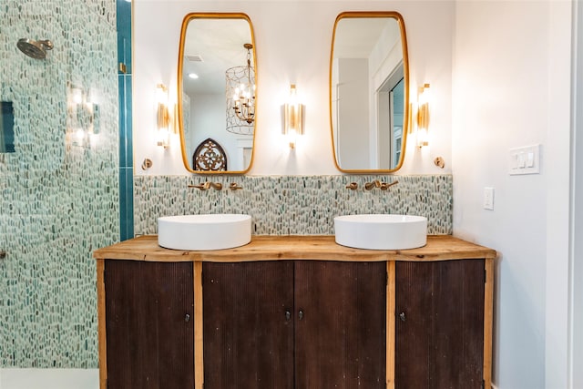 full bath featuring visible vents, double vanity, a sink, and tile walls