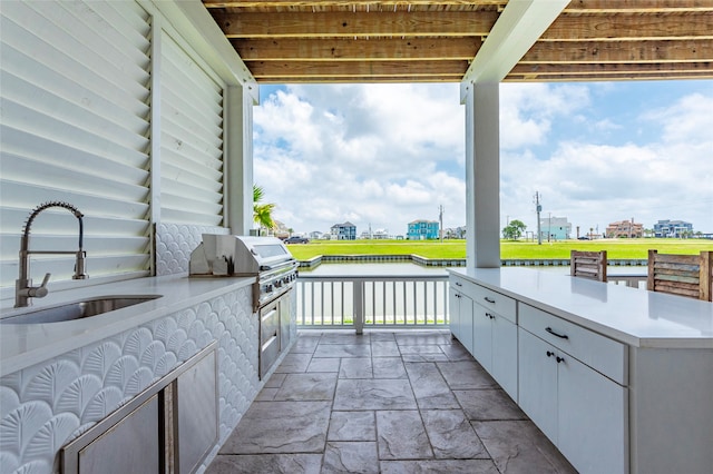 view of patio with area for grilling and sink