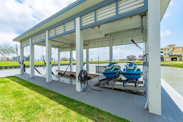 exterior space featuring boat lift, a water view, a lawn, a boat dock, and a carport