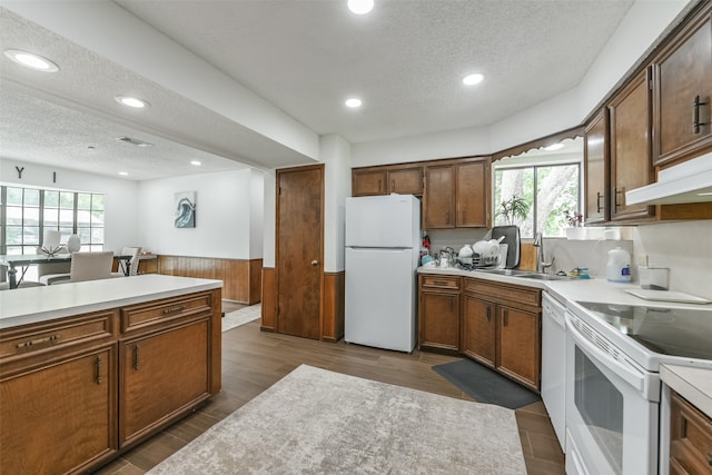 kitchen featuring dark hardwood / wood-style floors, sink, a textured ceiling, and white appliances