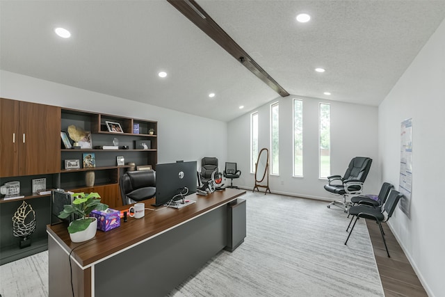 office featuring lofted ceiling with beams, light hardwood / wood-style flooring, and a textured ceiling