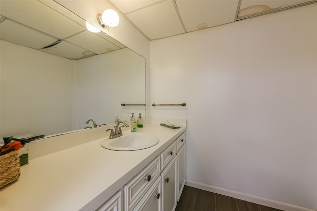 bathroom with hardwood / wood-style floors and large vanity