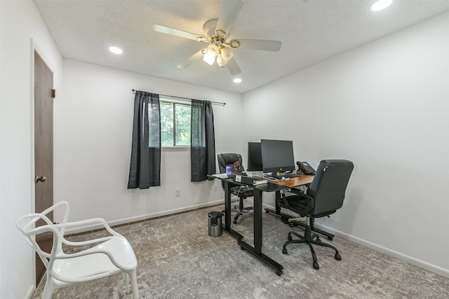 carpeted office featuring ceiling fan and a textured ceiling