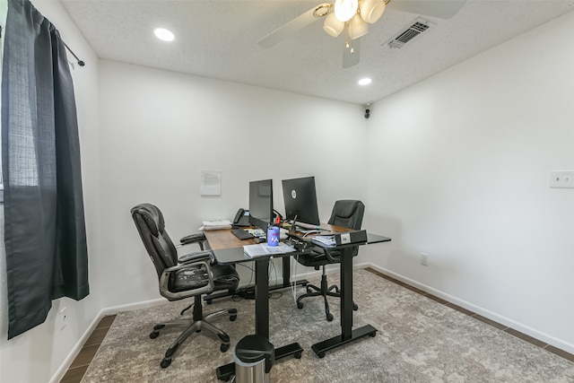 home office with ceiling fan and a textured ceiling