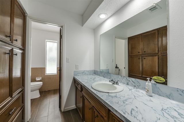 bathroom with large vanity and toilet