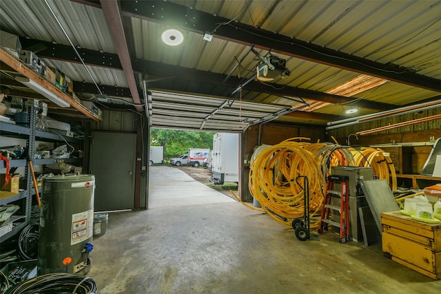 garage featuring a garage door opener and water heater