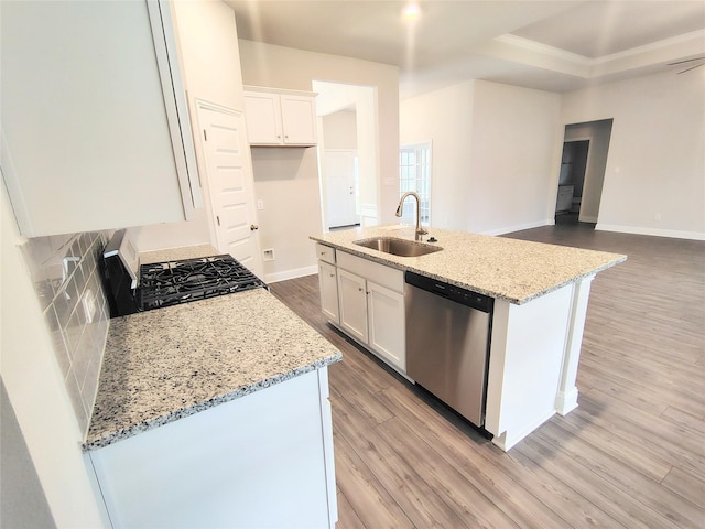 kitchen featuring sink, a center island with sink, white cabinets, and appliances with stainless steel finishes