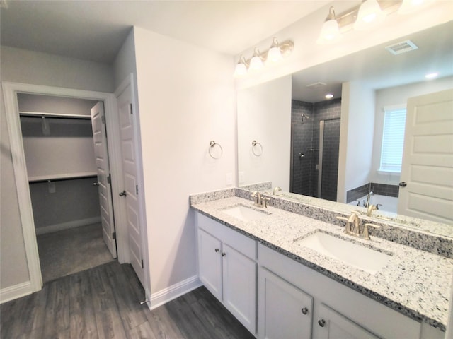 bathroom featuring vanity, hardwood / wood-style floors, and shower with separate bathtub