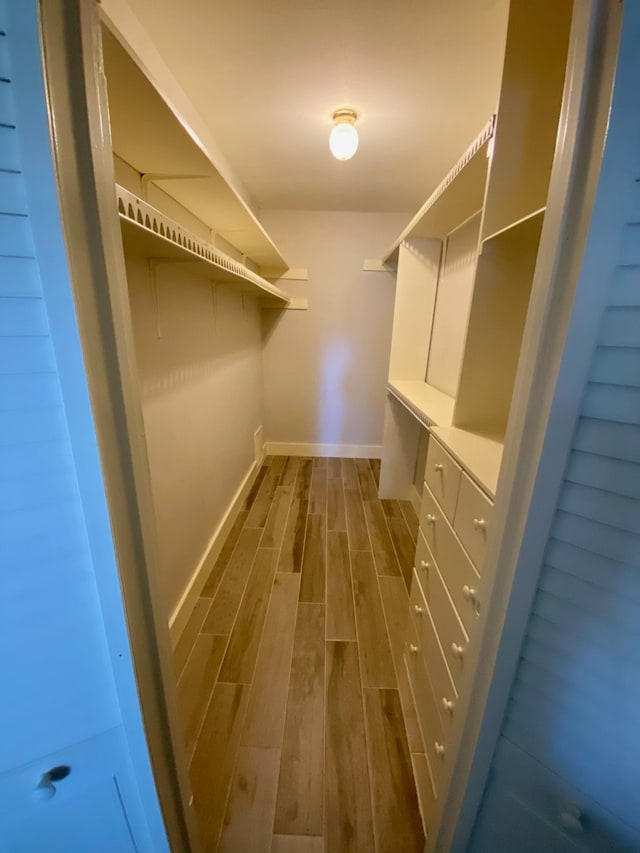 walk in closet with a mail area and dark hardwood / wood-style floors