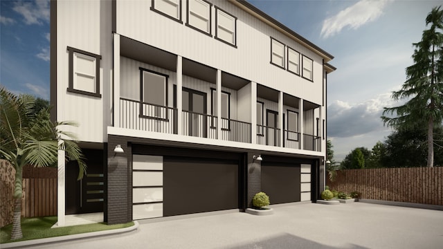 view of front of house featuring a balcony and a garage