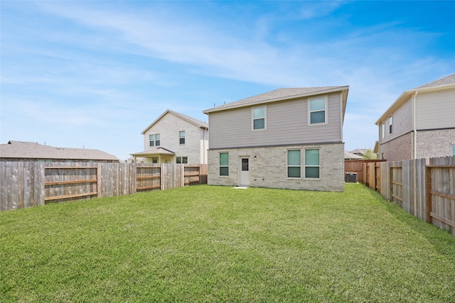 rear view of house featuring a yard