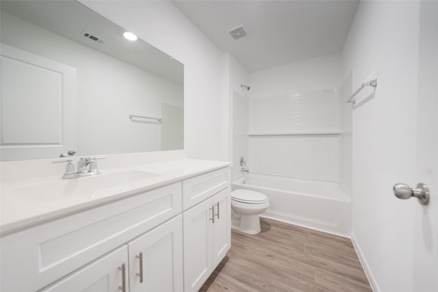 full bathroom with hardwood / wood-style floors, vanity, toilet, and shower / tub combination