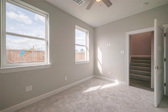 4748 Mallow St, Houston, TX 77033 - carpeted spare room featuring baseboards, ceiling fan, visible vents, and stairway