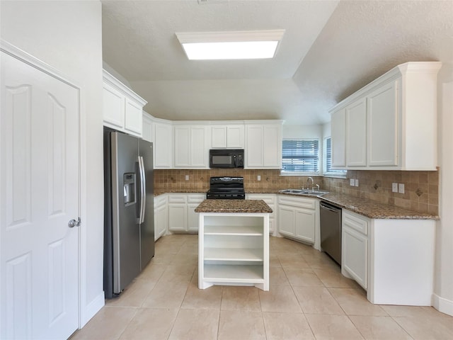 kitchen with a center island, sink, dark stone countertops, white cabinets, and black appliances