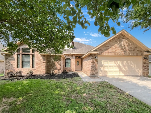 view of front of property with a front yard and a garage