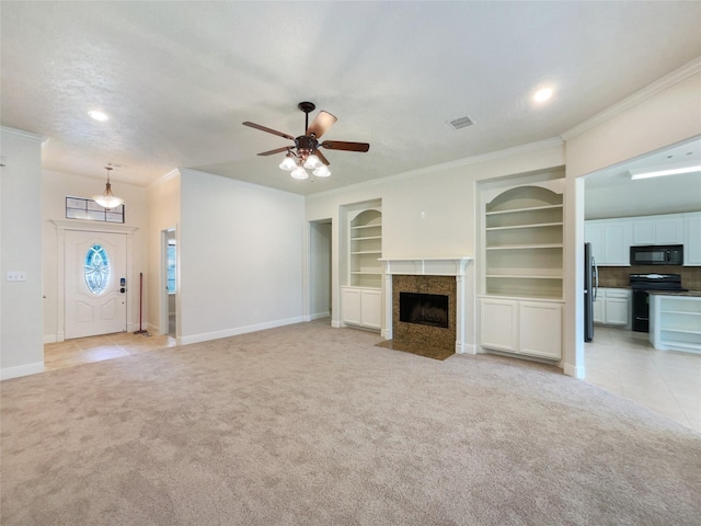 unfurnished living room featuring ceiling fan, light tile patterned flooring, crown molding, and built in shelves