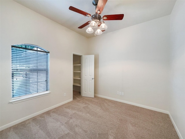 carpeted empty room featuring plenty of natural light and ceiling fan