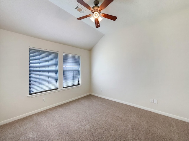 carpeted empty room with ceiling fan and lofted ceiling