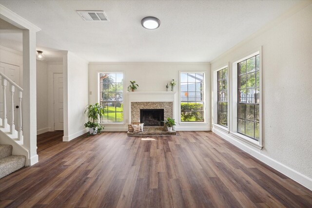 unfurnished living room featuring a textured ceiling and dark hardwood / wood-style floors