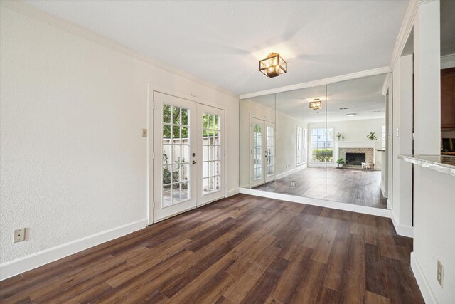 interior space featuring crown molding, french doors, and dark wood-type flooring