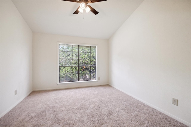 carpeted spare room with ceiling fan and lofted ceiling