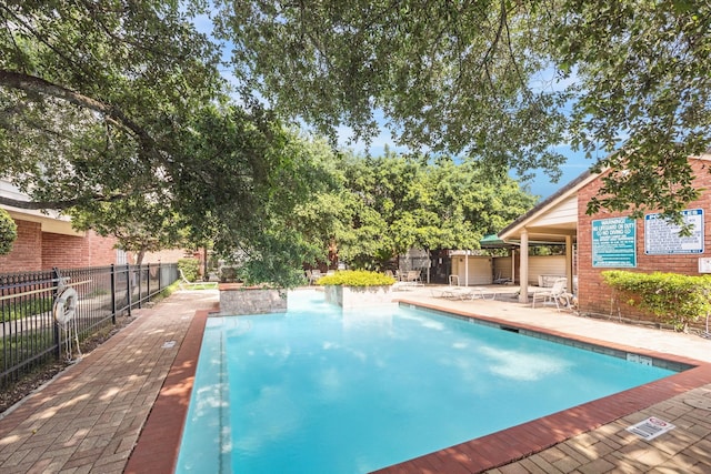 view of swimming pool featuring a patio area