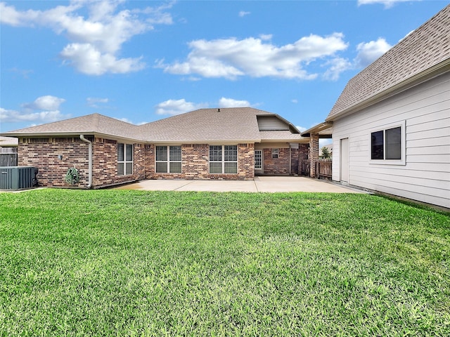 rear view of property featuring central air condition unit, a patio area, and a lawn