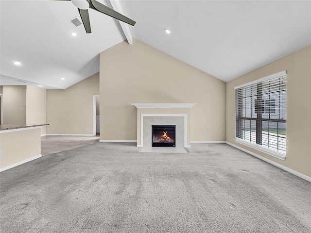 unfurnished living room featuring light carpet, vaulted ceiling with beams, a fireplace, and ceiling fan