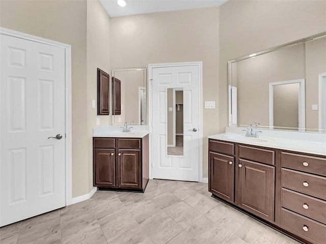 bathroom featuring vanity and a high ceiling