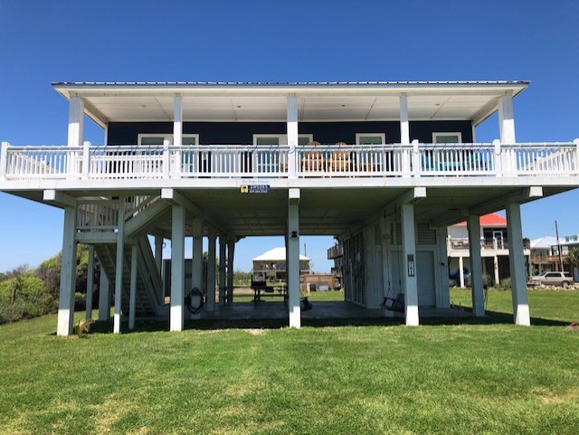 rear view of house featuring a lawn