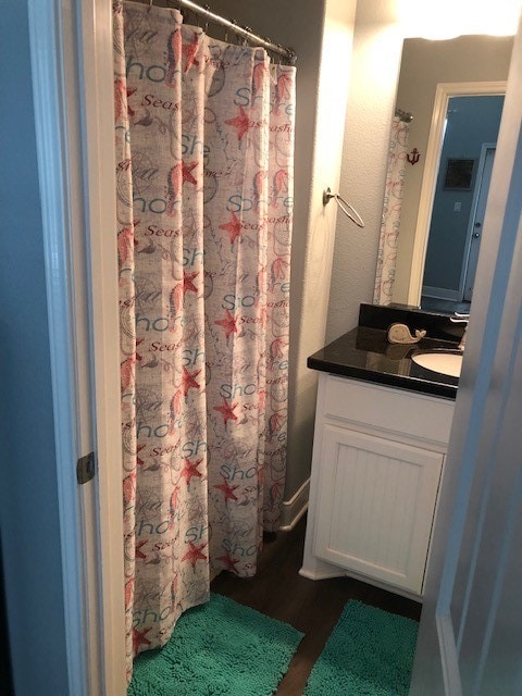 bathroom with hardwood / wood-style flooring and vanity