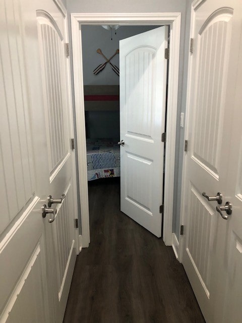 hallway with dark wood-type flooring