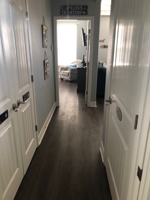 corridor with dark hardwood / wood-style floors