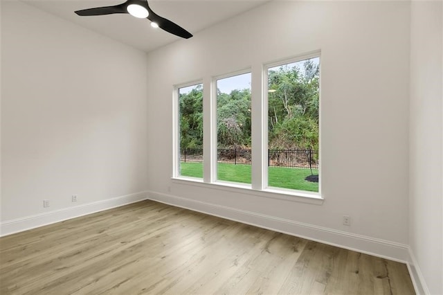 spare room with ceiling fan and light wood-type flooring